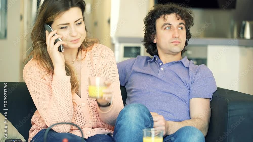 Woman talking on cellphone while sitting next to her boyfriend, steadycam shot
Woman talking on cellphone while sitting next to her boyfriend, steadycam shot