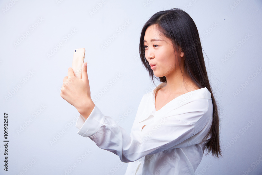 Chinese woman in white photographs herself Chinese woman in white photographs herself