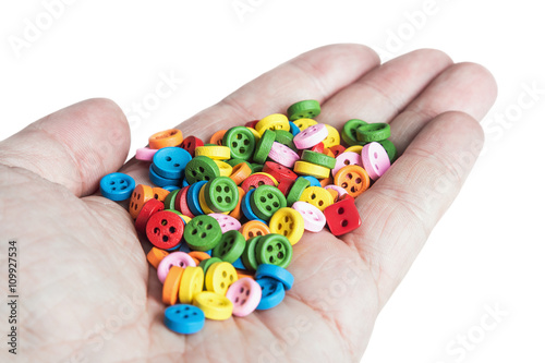 Multi colored buttons in his hand