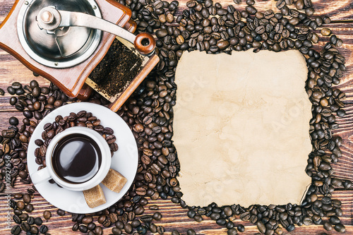 cup of warm coffee and coffee grinder