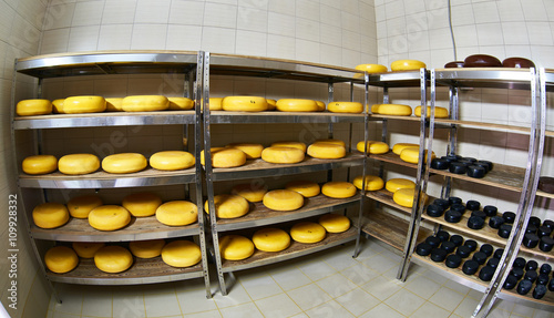 Cheese factory warehouse with shelves of product capretto and la photo