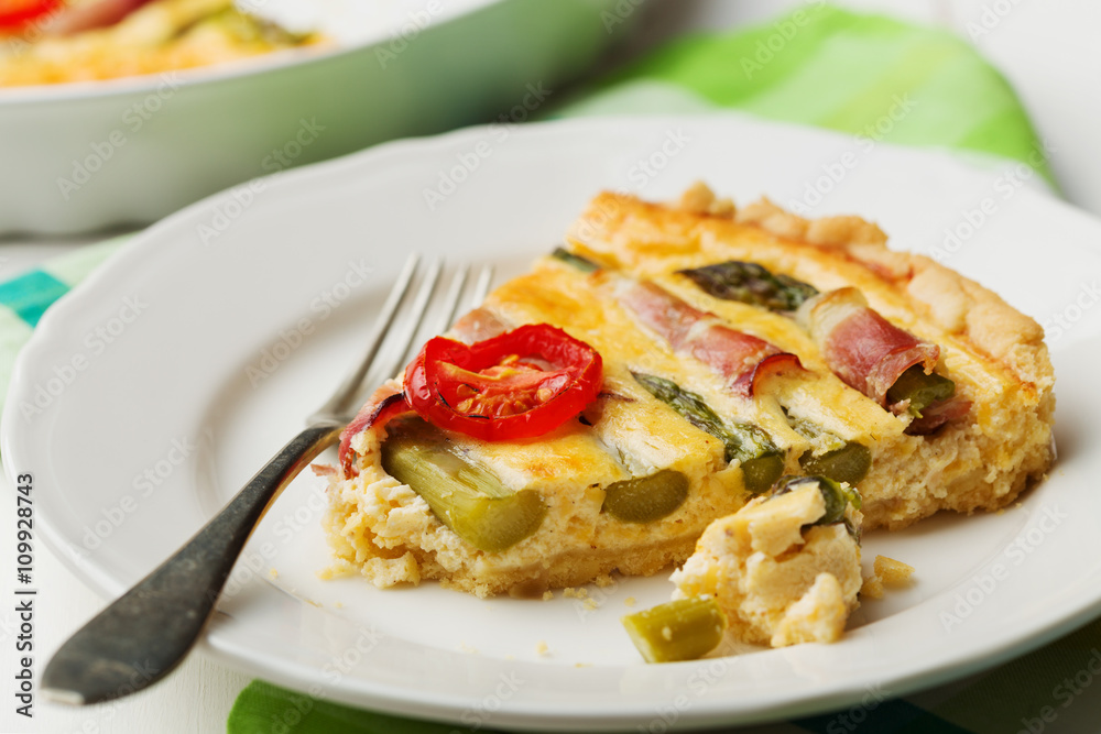 Tart with asparagus and tomatoes on white wooden background. Tart with asparagus and tomatoes on white wooden background.