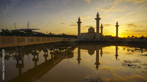 Reflection of a modern beautiful mosque during blue hour sunrise