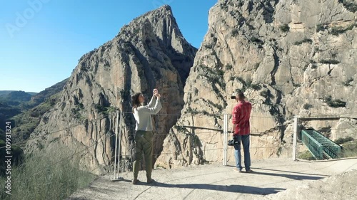 People taking photos with cellphones of El Caminito del Rey
