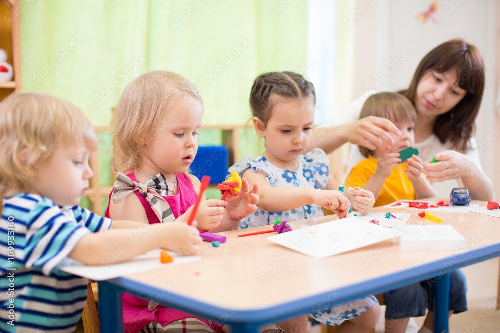 kids learning arts and crafts in kindergarten with teacher kids learning arts and crafts in kindergarten with teacher