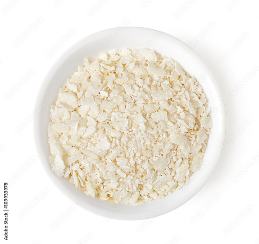 Bowl of rice flakes isolated on white, top view Bowl of rice flakes isolated on white, top view