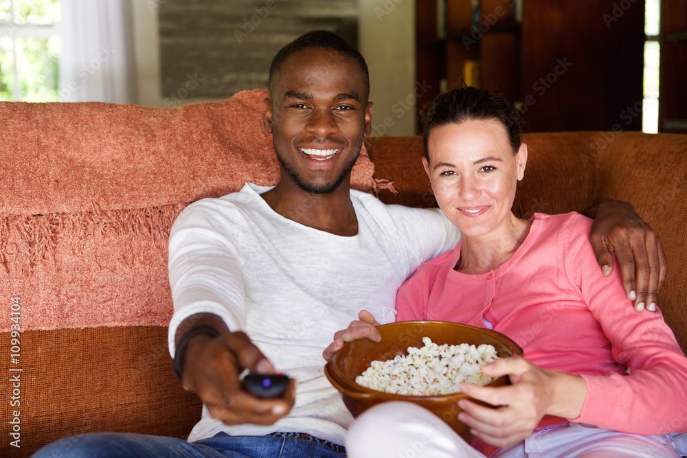 Mixed race couple watching a movie at home Mixed race couple watching a movie at home