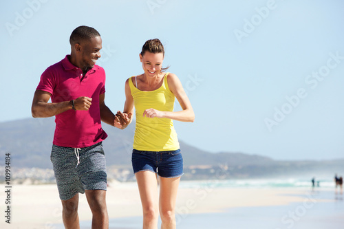Mixed race couple running on the beach