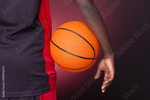 Back view of afro american basketball player holding a ball on d © cristovao31