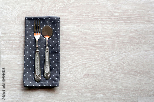 Shabby chic table setting with wooden background and vintage cutlery. Top view with copy space