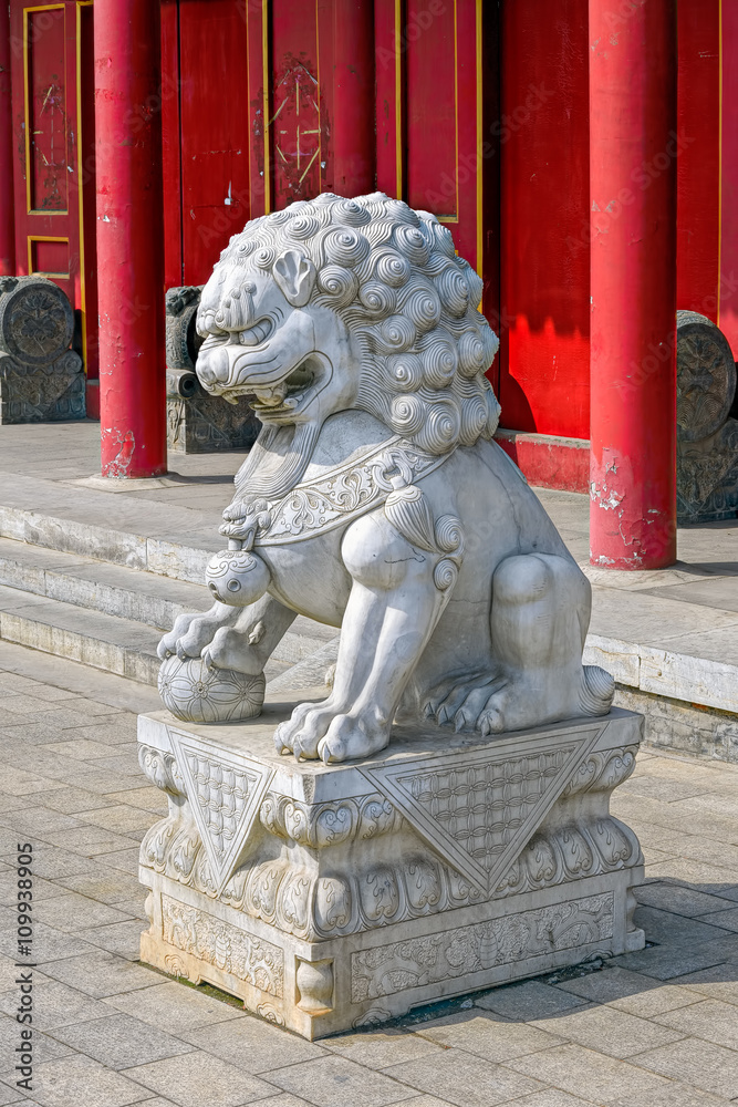 Chinese stone lion at the gate of Chinese temple Chinese stone lion at the gate of Chinese temple