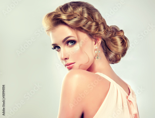 Beautiful model girl with elegant hairstyle . Beautiy woman with fashion wedding hair and colourful makeup 