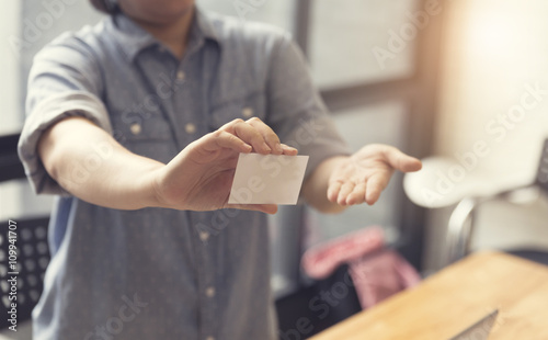 woman's hand holding white name card