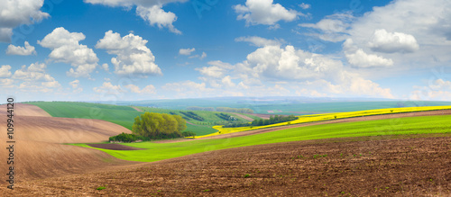 beautiful spring hills landscape with colorful fields photo