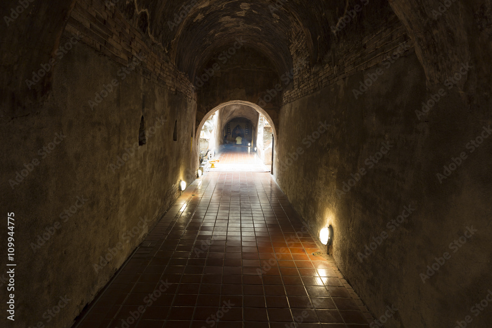 golden buddha statue in cave tunnel