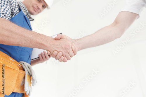 Construction workers shaking hand