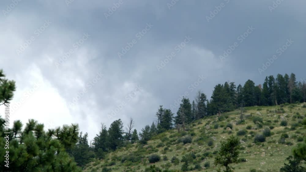 Storm clouds approaching the mountain range in Rocky Mountain National Park. Handheld organic feel natural lighting Storm clouds approaching the mountain range in Rocky Mountain National Park. Handheld organic feel natural lighting