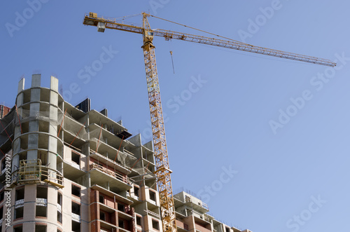 Construction crane on the building background