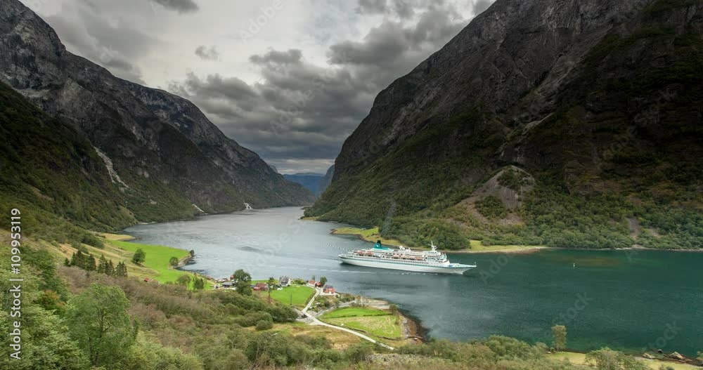 Ship cruises in fjord in Naeroyfjord near Gudvangen, Norway - 4K Timelapse