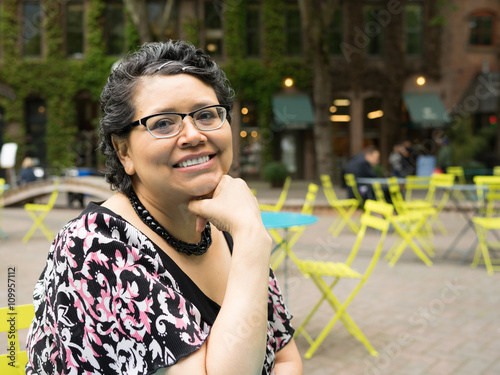 Happy Hispanic Woman In 40's Enjoys Outdoor Dining