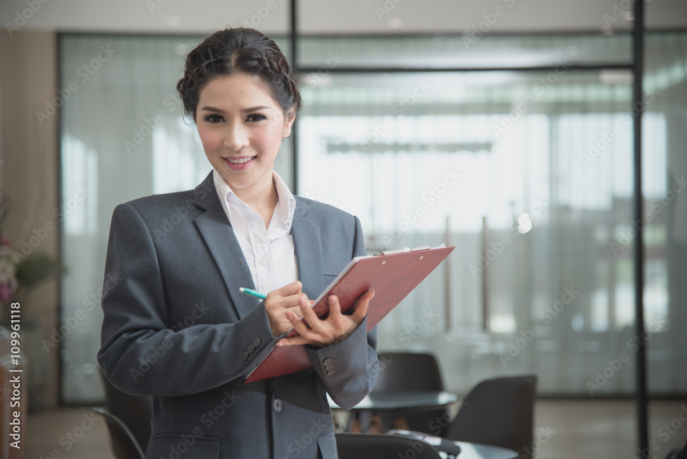 business woman with pen and document in hand with office glass w business woman with pen and document in hand with office glass w