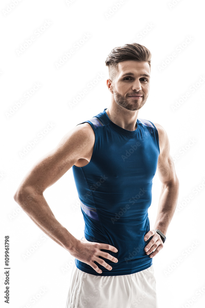 Skillful young sportsman is posing with joy Skillful young sportsman is posing with joy