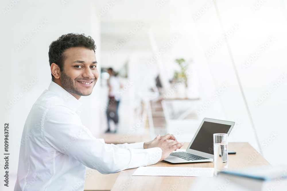 Attractive young man is working on a computer