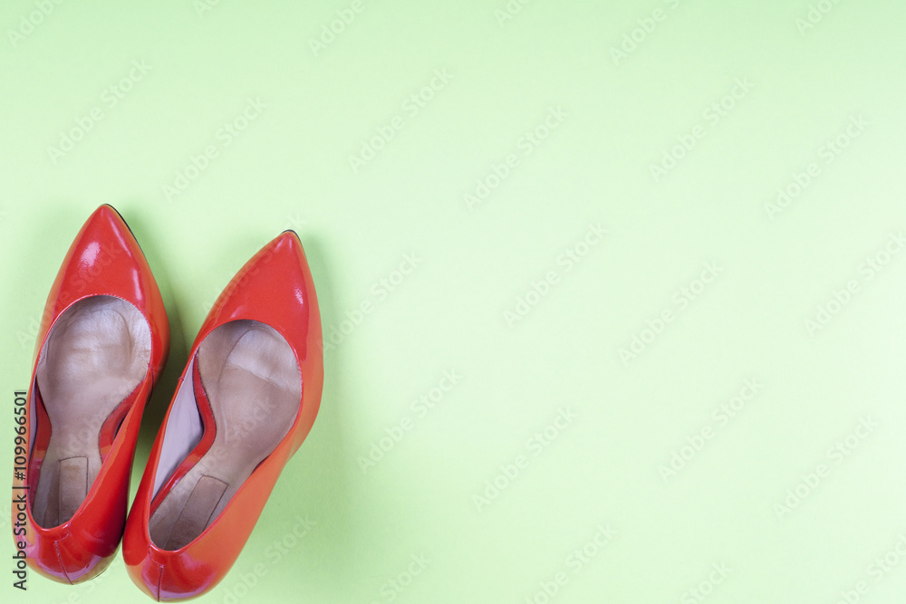 A picture of different shoes, Shot of several types of shoes, Several designs of  women shoes. Leather Shoe. Pile of various female shoes on on  light blue background. Copy space for text.