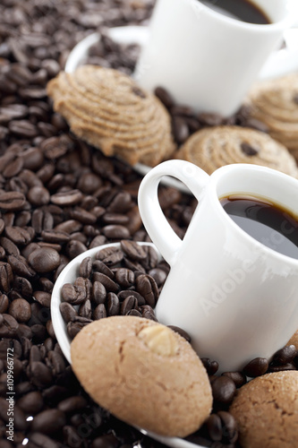 cup of coffee with beans and cookies.