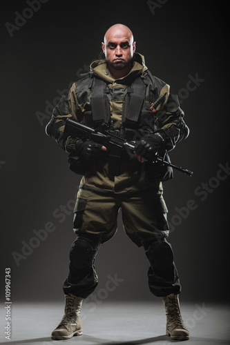 soldier man hold Machine gun on a dark background