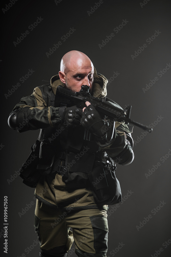 soldier man hold Machine gun on a  dark background