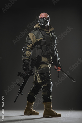 soldier man hold Machine gun on a dark background