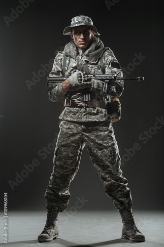 Special forces soldier man with Machine gun on a  dark background