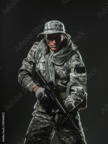 Special forces soldier man with Machine gun on a  dark background