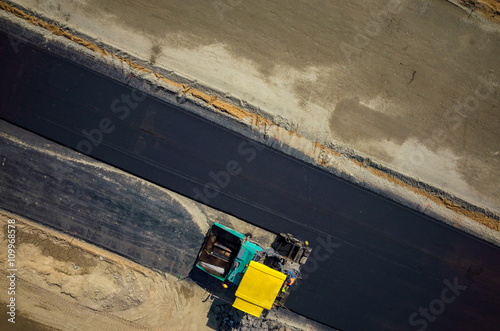 Road rollers working on the construction site aerial view