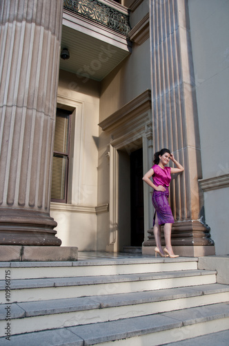 Woman in Thai silk traditional dress stand in old building