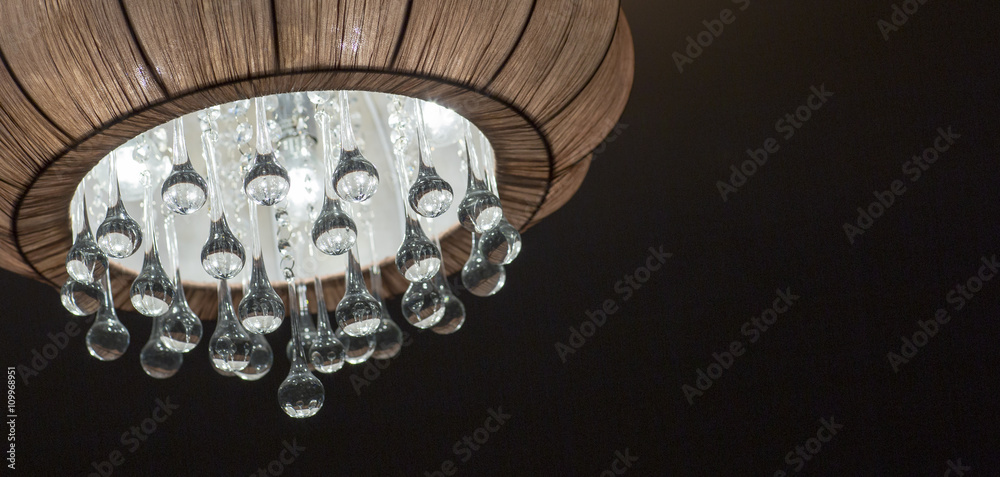 The chandelier is made of fabric with crystal pendants. A lit chandelier, bedroom interior. The chandelier is made of fabric with crystal pendants. A lit chandelier, bedroom interior.