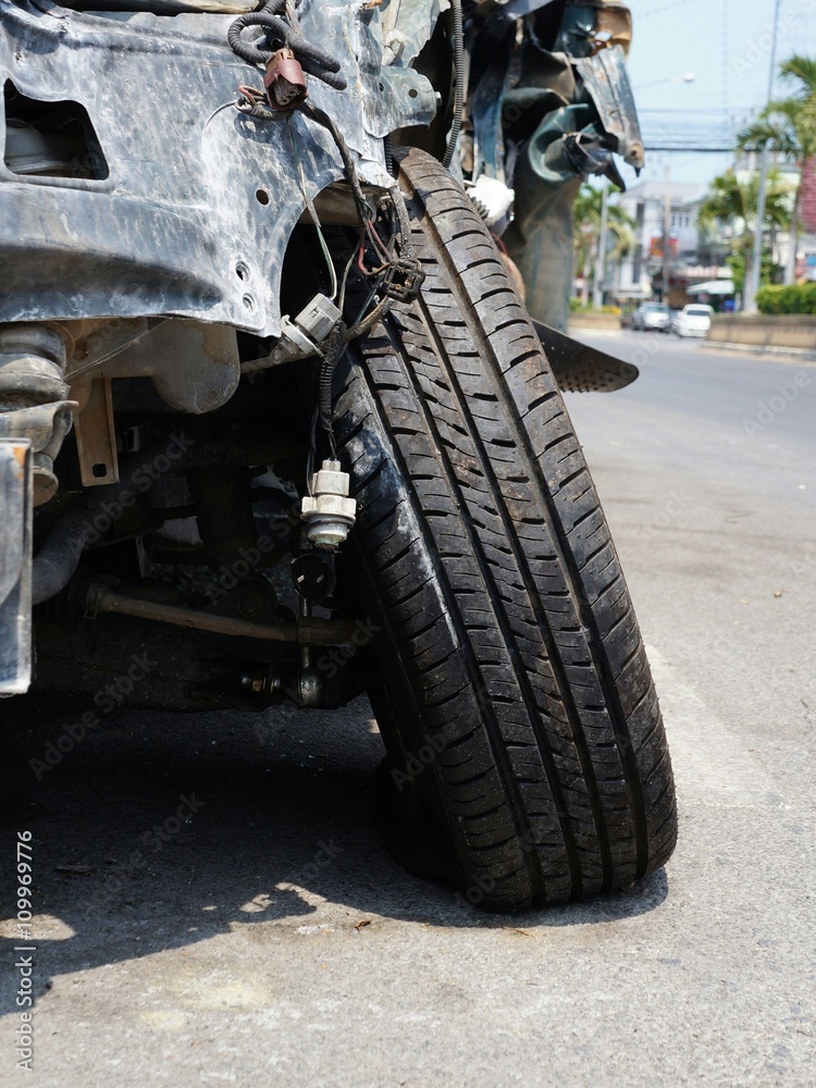 Closeup Shot of Flat Tire and Broken Axis on Wrecked Car after Accident