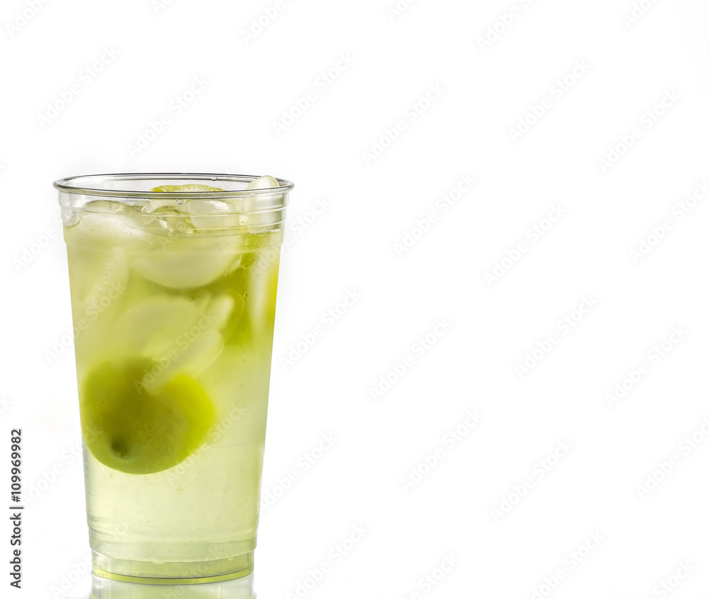 Fresh squeezed lemonade in a clear cup with lemons and ice. Fresh squeezed lemonade in a clear cup with lemons and ice.