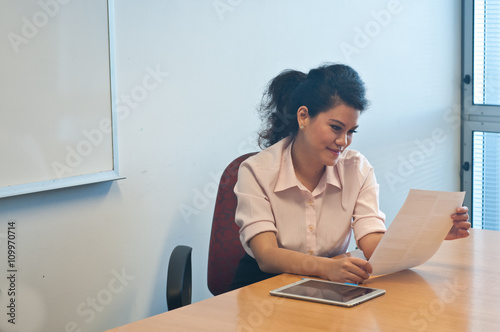 Business woman examining contract agreement in office