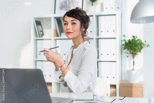 Young attractive office worker drinking cup of tea, having coffee break in the morning, getting ready for work day.