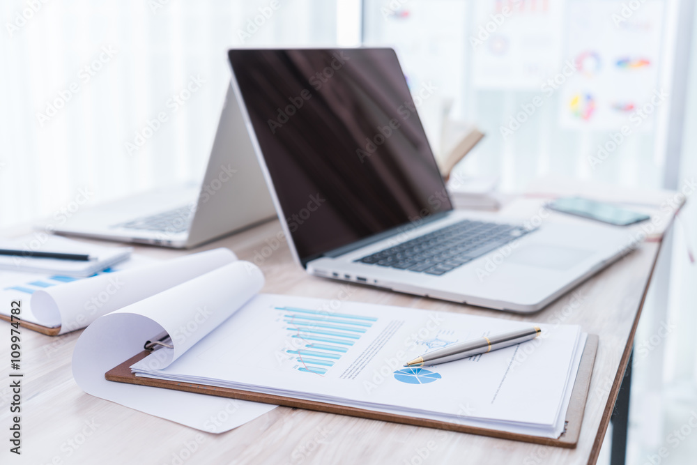 Financial charts on the table with laptop.. Financial charts on the table with laptop..