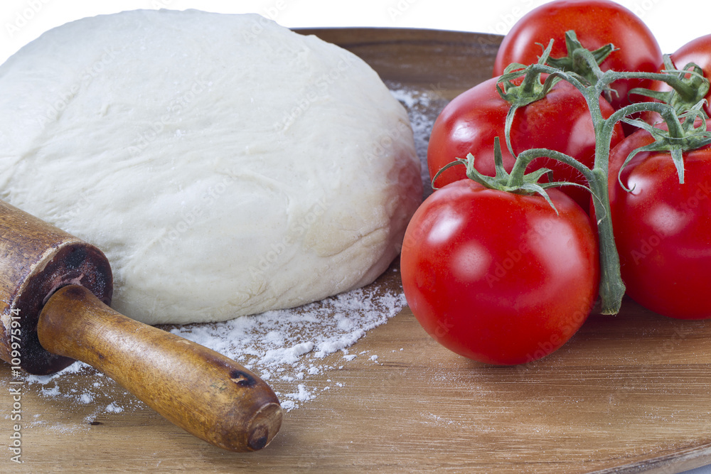 dough, rolling pin and tomatoes dough, rolling pin and tomatoes