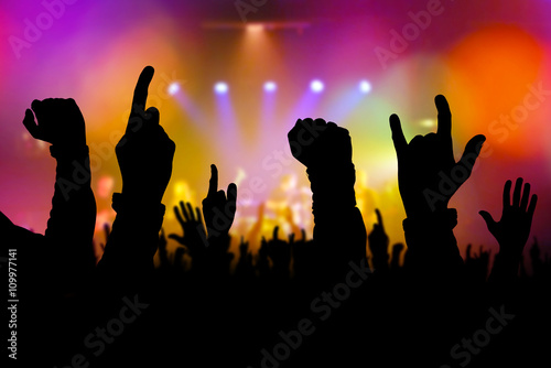 Concert crowd hands supporting band on stage