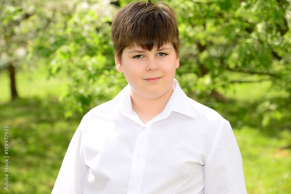 Portrait of a boy teenager in garden Portrait of a boy teenager in garden