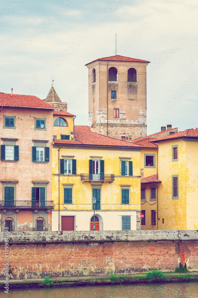 Medieval buildings along river Arno in Pisa, Italy.