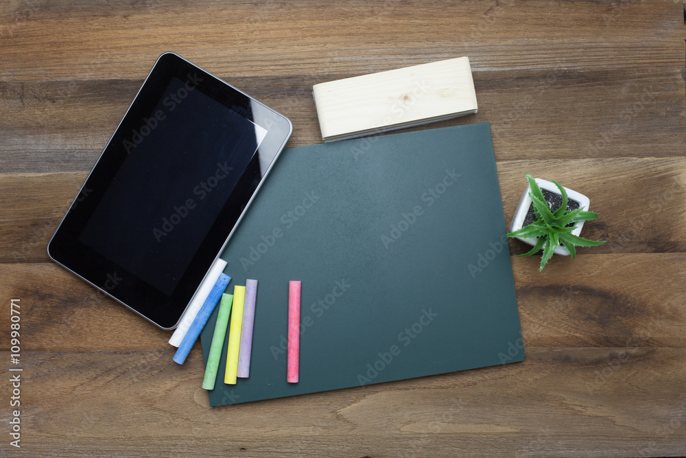 Tablet ,Chalks,Chalk board and eraser on wooden background Tablet ,Chalks,Chalk board and eraser on wooden background