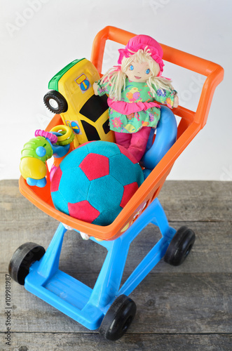 toys collectionon in cart on wooden floor photo