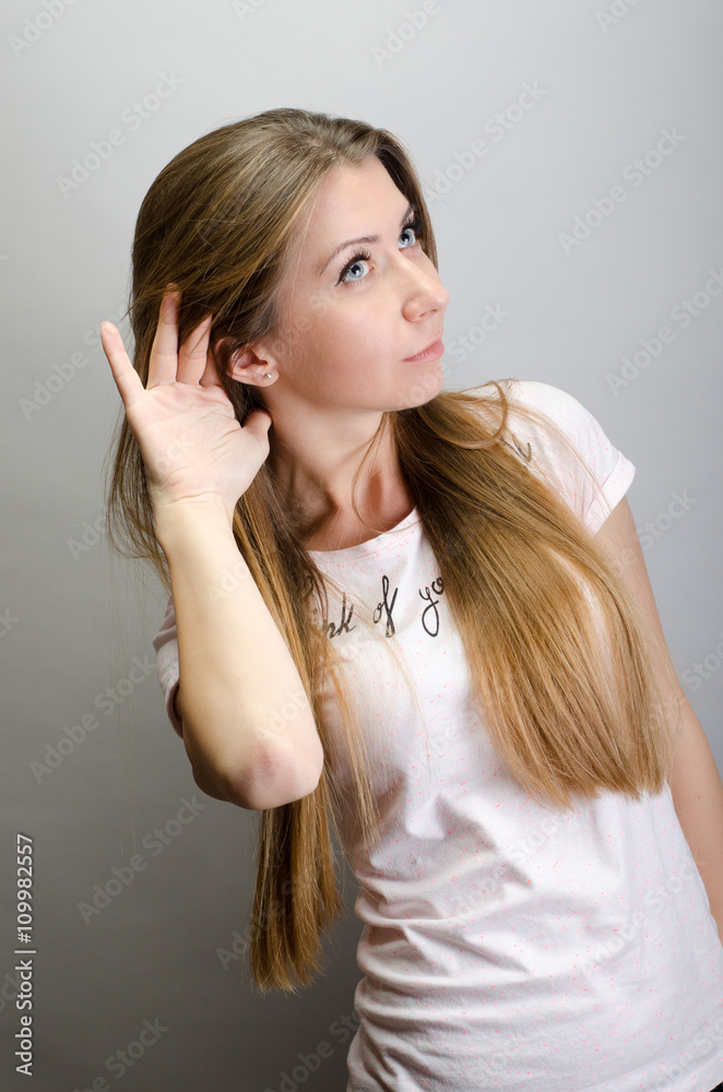 Young woman surprised trying to hearing something Young woman surprised trying to hearing something