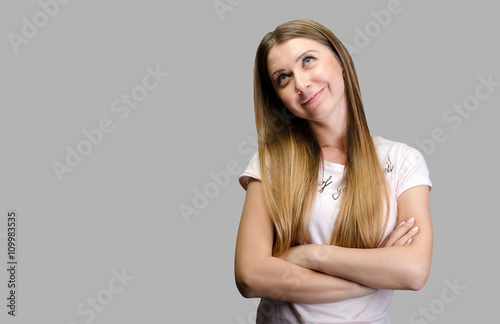 Happy young woman standing arms crossed